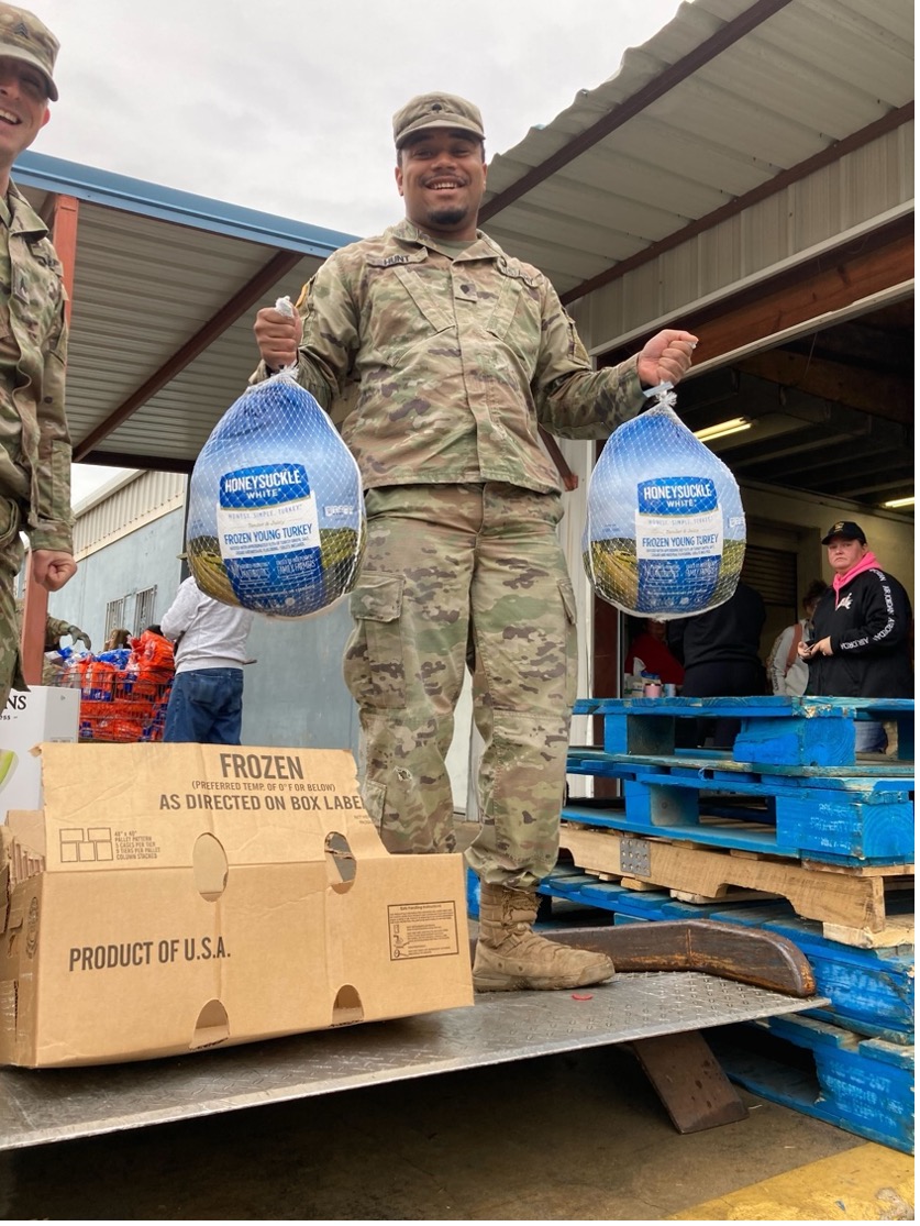 Veteran at the Food Care Center holding a frozen turkey